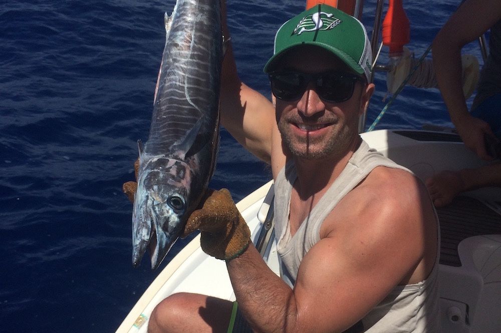 client getting a fish during our sailing cruise to marie-galante