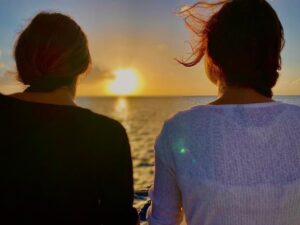 Girls enjoying the sunset sailing back from there sailing and snorkeling day tour to les saintes.